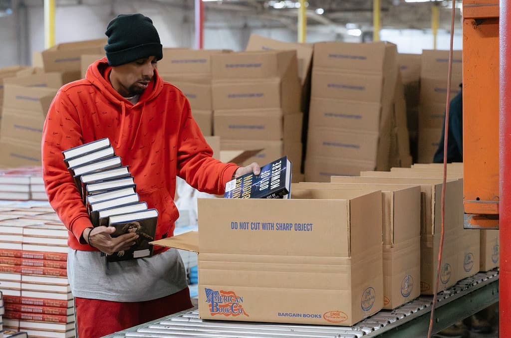 Lots of boxes of books sitting on palettes in the ABC warehouse ready to move