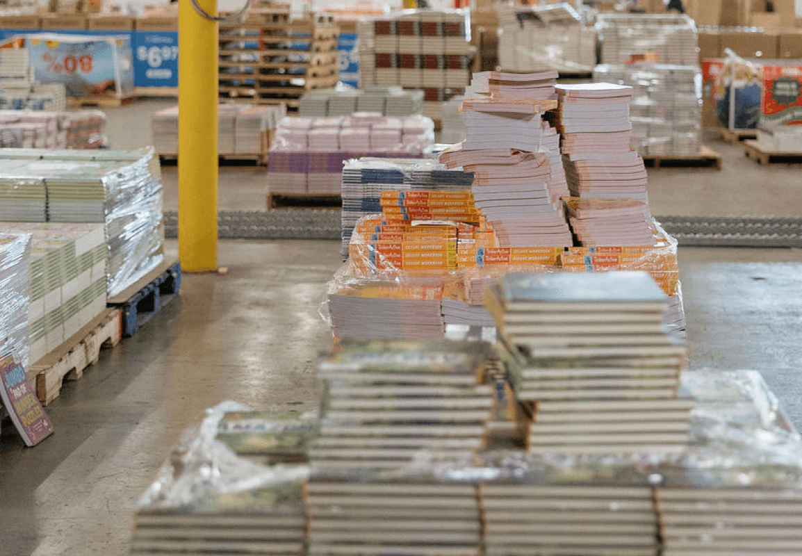 Books piled onto several palettes within the ABC warehouse
